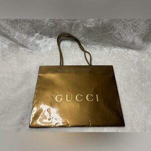 A Brown Gucci medium shopping gift bag